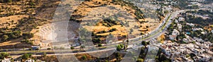 Aerial photo of massive ancient theatre of Halicarnassus, Bodrum, Turkey with road crossing town. historical places