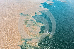 Aerial photo of the meeting of the waters of the Amazon Rivers with the TapajÃÂ³s River in SantarÃÂ©m, ParÃÂ¡, Brazil. photo