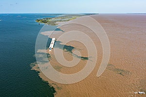 Aerial photo of the meeting of the waters of the Amazon Rivers with the TapajÃÂ³s River in SantarÃÂ©m, ParÃÂ¡, Brazil. photo