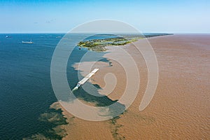 Aerial photo of the meeting of the waters of the Amazon Rivers with the TapajÃÂ³s River in SantarÃÂ©m, ParÃÂ¡, Brazil. photo