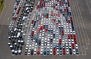 Aerial photo of new passenger cars and trucks at a shipping port in Australia