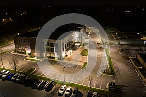 Aerial photo office building and parking lot at night