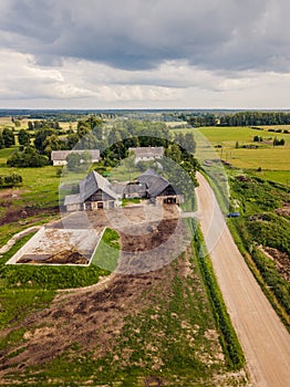 Aerial Photo of old Farmer houses with Road by its Side and Agriculture Fields Around it in Early Spring on Sunny Day