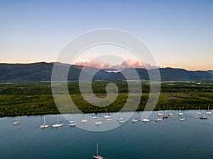 Aerial photo of perfect blue water, sunset sky and boats docked