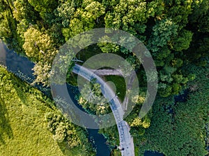 Aerial Photo of Road going by the River under the Trees, Top Down View in Early Spring on Sunny Day