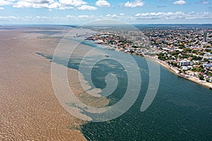 Aerial photo of SatarÃÂ©m City and the meeting of the waters of the Amazon Rivers with the TapajÃÂ³s River in ParÃÂ¡, Brazil. photo