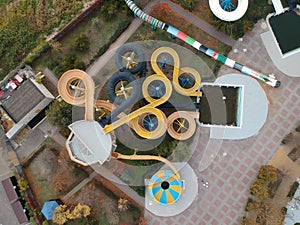 Aerial photo of small aqua park with colorful tubes, view from above, abandoned, nobody