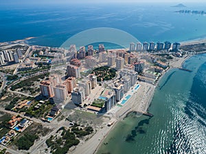Aerial photo of tall buildings and the beach on a natural spit of La Manga between the Mediterranean and the Mar Menor, Cartagena