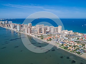 Aerial photo of tall buildings and the beach on a natural spit of La Manga between the Mediterranean and the Mar Menor, Cartagena
