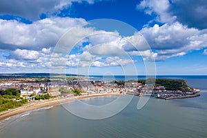 Aerial photo of the town centre of Scarborough in East Yorkshire in the UK showing the coastal beach and harbour with boats and