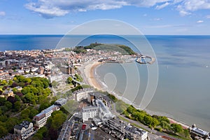 Aerial photo of the town centre of Scarborough in East Yorkshire in the UK showing the coastal beach and harbour with boats and