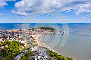 Aerial photo of the town centre of Scarborough in East Yorkshire in the UK showing the coastal beach and harbour with boats and