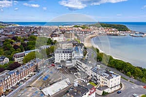 Aerial photo of the town centre of Scarborough in East Yorkshire in the UK showing the coastal beach and harbour with boats and