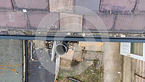 Aerial photo of a typical British terrace house showing tiles on the roof and dirty gutters that need to be cleaning