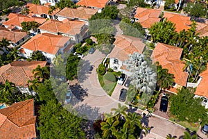 Aerial photo upscale Miami neighborhood with palm trees and cars in driveway