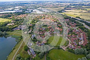 Aerial photo of the village of Milton Keynes in the UK showing a typical British housing estate on a sunny summers day taken with