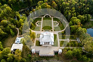 Aerial photo of white palace manor in forest and park