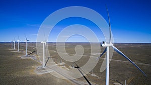 Aerial photo of windmills powered by aerofoil that provide sustainable energy.