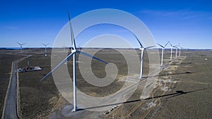 Aerial photo of windmills powered by aerofoil that provide sustainable energy.