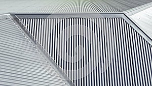 Aerial photograph of a grey corrugated iron roof in the sunshine