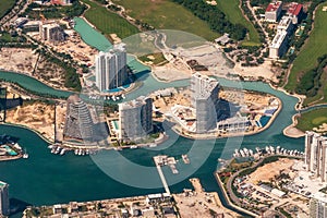 Aerial photograph of the residential apartments on the water in Cancun, Shark Tower, Aria Puerto, and the Marea residences