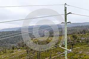 Aerial photograph of a wooden powerline pole and wires