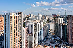 Aerial photography, construction site of high-rise residential buildings on a summer day against the background of a blue horizon