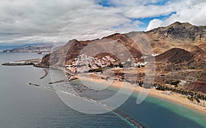 Aerial photography drone point of view of Playa de Las Teresitas beach picturesque distant view of mountainous terrain bright