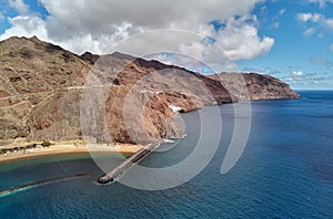 Aerial drone point of view of Playa de Las Teresitas beach picturesque distant view of mountainous terrain bright