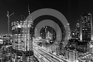 Dubai at night a city which continuously grows in black and white