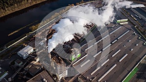 Aerial photography factory for processing wood. The smoke from the chimneys