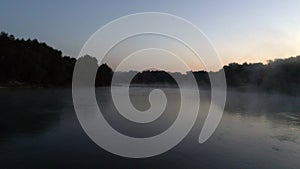 Aerial photography of the river at dawn. Rising mist from the river against the background of the rising sun