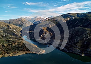 Aerial photography rocky snow-capped Sierra Nevada mountains Embalse de Canales Reservoir in Guejar Sierra photo