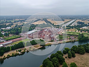 Aerial photography shot of the Hampton Court Palace beside the River Thames in the UK