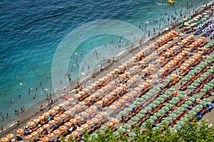 Aerial photography of tourists playing and taking sunbath on a s