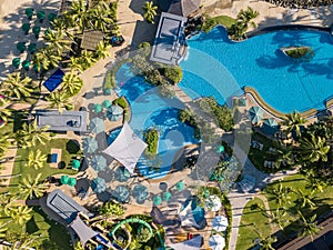 Aerial photography of tropical island resort hotel  swimming pool  sun loungers and water park