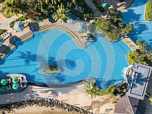 Aerial photography of tropical island resort hotel, swimming pool, sun loungers and water park