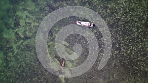 Aerial photography view of Wakatobi islands with a white boat, Southeast Sulawesi, Indon