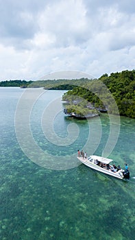 Aerial photography view of Wakatobi islands with a white boat, Southeast Sulawesi, Indon