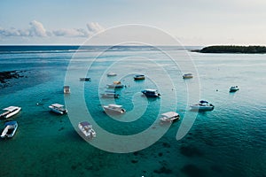 Aerial picture of the east coast of Mauritius Island. Beautiful lagoon of Mauritius Island shot from above. Boat sailing in