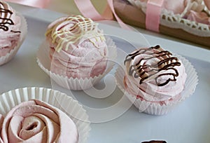 Aerial pink cherry marshmallows. Different shapes and sizes. Sprinkled with dextrose. Garnished with Chocolate