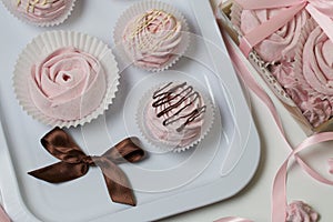 Aerial pink cherry marshmallows. Different shapes and sizes. Sprinkled with dextrose. Garnished with Chocolate