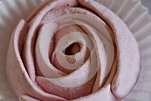 Aerial pink cherry marshmallows. In the form of a rose. Sprinkled with dextrose. Close-up