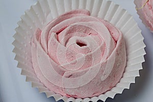 Aerial pink cherry marshmallows. In the form of a rose. Sprinkled with dextrose. Close-up