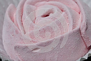 Aerial pink cherry marshmallows. In the form of a rose. Sprinkled with dextrose. Close-up