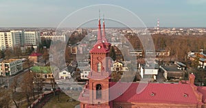 AERIAL. Point of interest 360 drone shot of St. Peter and Paul`s church in Panevezys. Spring afternoon in Lithuania