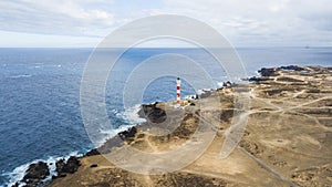 Aerial point of view of lighthouse on the coast to make light on the ocean for ships. many roads to go everywhere and discover