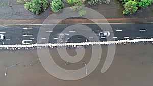 Aerial pov view depiction of floodin - Driving car on flooded road during flood caused by torrential rains.