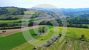 Aerial pullback from Belmonte Piceno in the Fermo province of Marche region, Italy, with fields, atmosphere