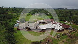 Aerial Pulling Away From Third World School with US or Liberian Flag on Pole